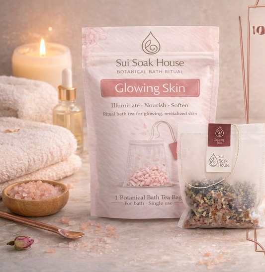 Sui Soak House botanical bath tea bag packaging with bath salts and candle on a wooden surface.