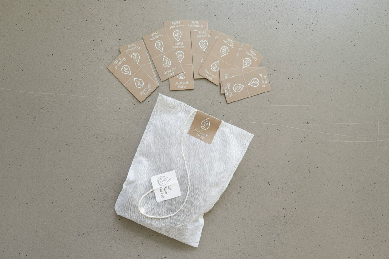 White fabric bag with a tag and brown cards on a gray surface